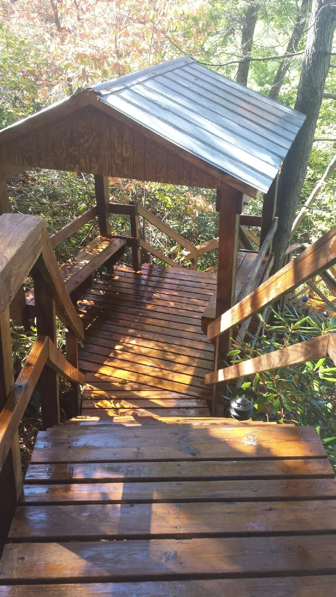Freshly stained wood walkway and covered shelter with a metal roof in Donegal